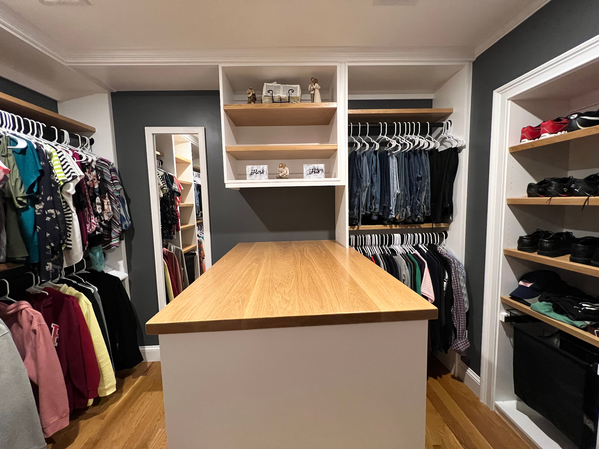Custom walk-in closet with built-in storage by Cane Hill Wood Works in Weston MA.